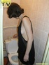 Lusty brunette takes her turn in sitting on the toilet throne and releases