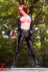 Redhead in black and gold latex outfit shows hot pink bra on skateboard