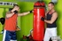 Hunk boxer in red shirt and blue shorts makes out with his handsome trainer