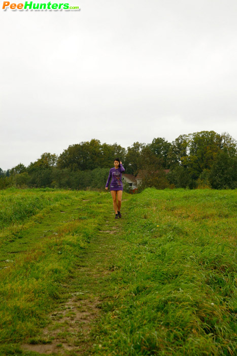 Girl pulls the hem of her dress up to pee outdoors - XXXonXXX - Pic 1