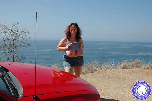 Busty redhead flashes her tits to the ocean - XXX Dessert - Picture 1