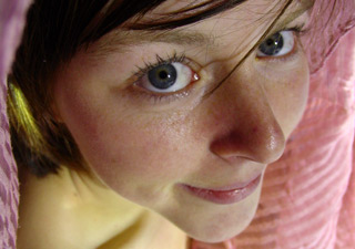 Brunette chick with a feather in her mouth shooting herself naked outdoors - XXXonXXX - Pic 1