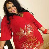 Plump ebony mom in red dress gives titjob - Picture 1