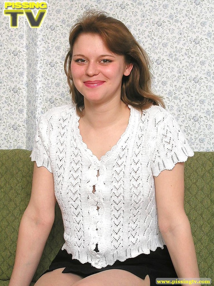 Alluring busty brunette beauty lounges on a living room sofa naked then positions herself and releases a golden shower of pee on the floor - XXXonXXX - Pic 1