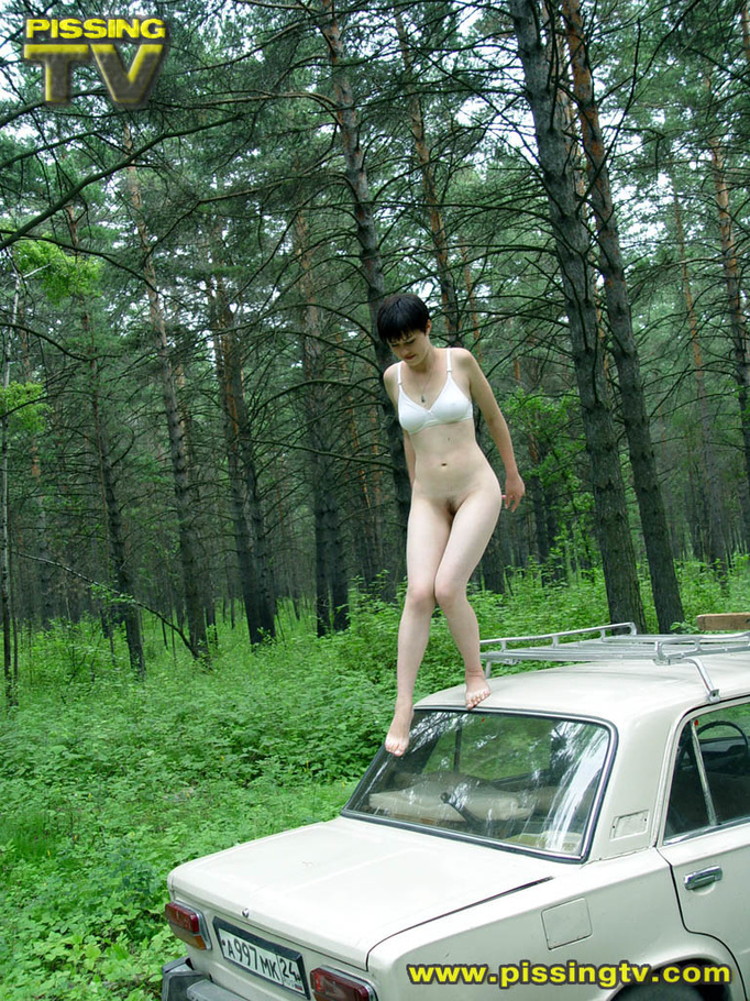 Daring brunette teen balances on a ladder proped on two cars, squats and relieves herself right there with out caring as to who is watching her - XXXonXXX - Pic 19