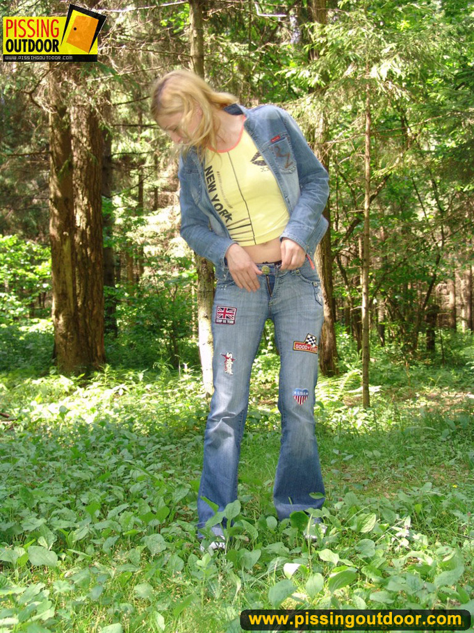 Sexy blonde wearing blue denin and black panties bends low to piss in the woods - XXXonXXX - Pic 2