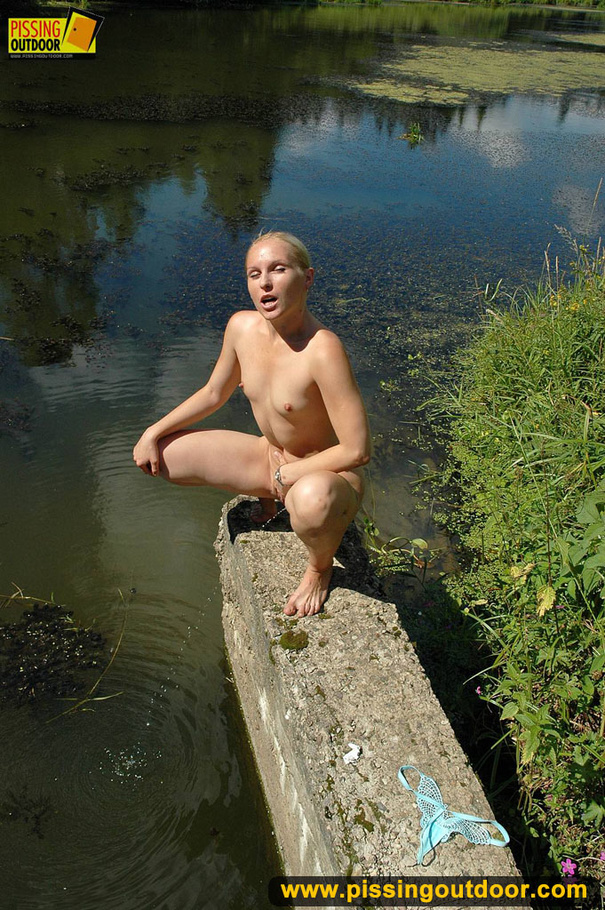 Sexy blonde with hot booty climbs concrete ledge to piss into the river below - XXXonXXX - Pic 12