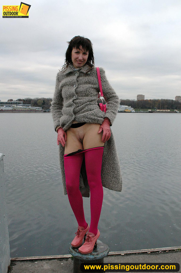 Babe walking outdoors makes a quick stop on an embankment to let out hot piss - XXXonXXX - Pic 7