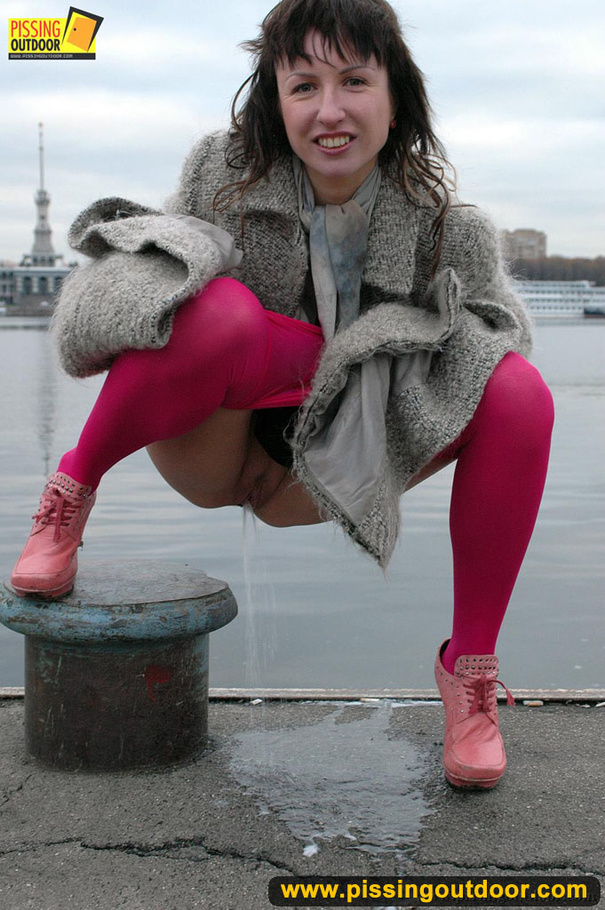 Babe walking outdoors makes a quick stop on an embankment to let out hot piss - XXXonXXX - Pic 17