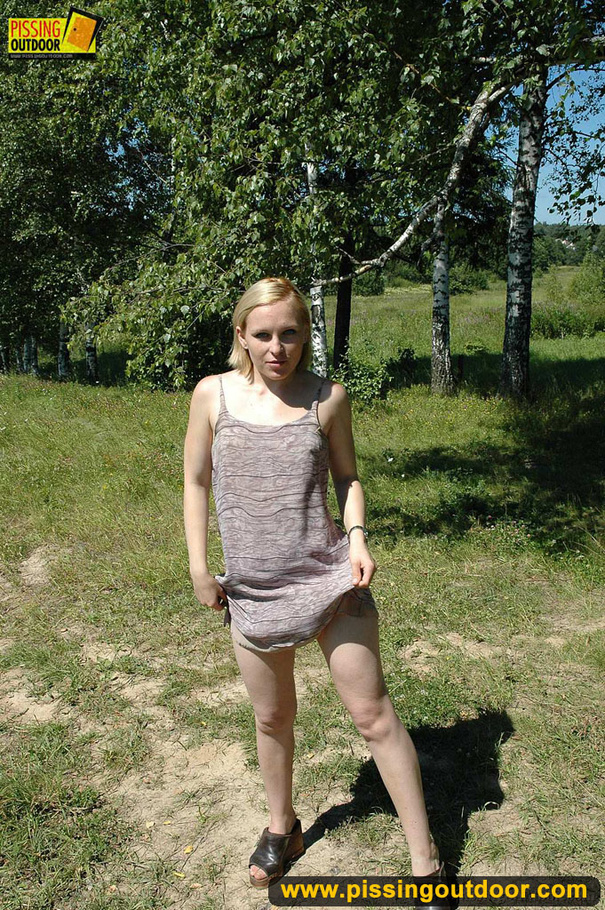 Blonde naughty chick slides panties to the side as she stands to urinate on road - XXXonXXX - Pic 1