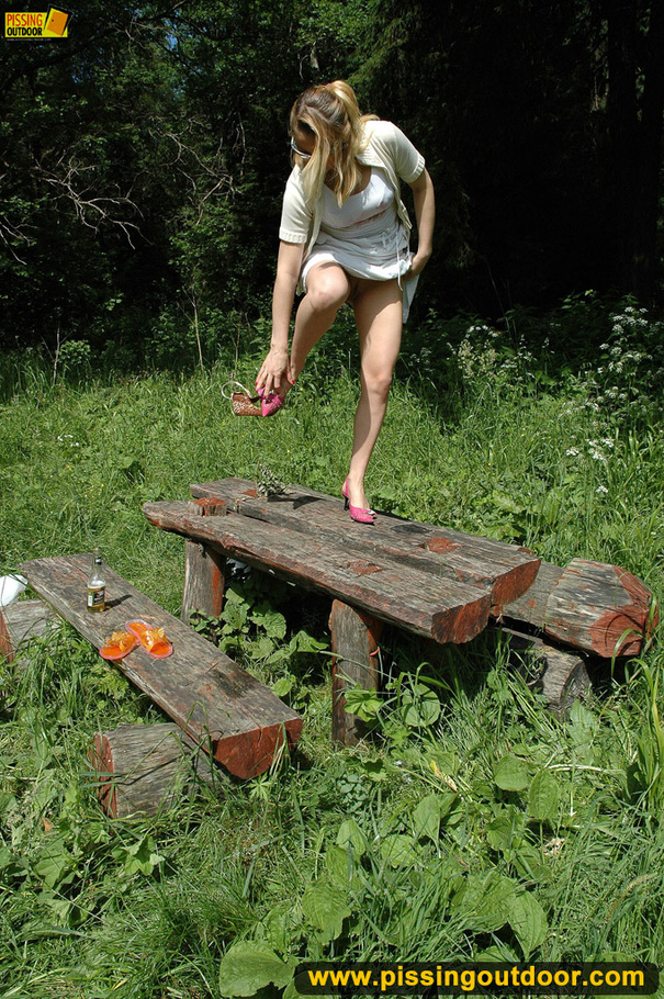 Sweet looking drinking blonde in glasses goes out to bend down to piss on wood - XXXonXXX - Pic 1