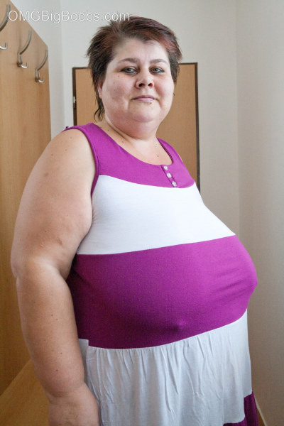 BBW in a striped dress demonstrating her milk farm - Picture 1