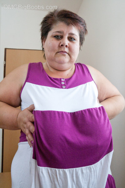 BBW in a striped dress demonstrating her milk farm - Picture 4
