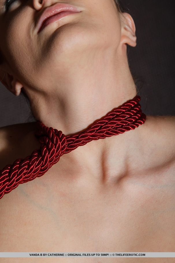 Naked brunette playing with a red rope on a - XXX Dessert - Picture 8