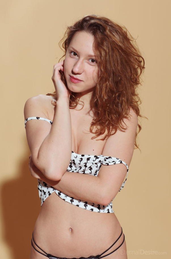 Lovely teen redhead undresses to pose on a  - XXX Dessert - Picture 2