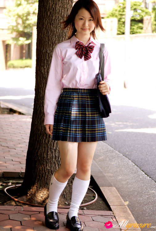 Doe in a pink blouse and a plaid skirt poses on a white sofa. - XXXonXXX - Pic 4