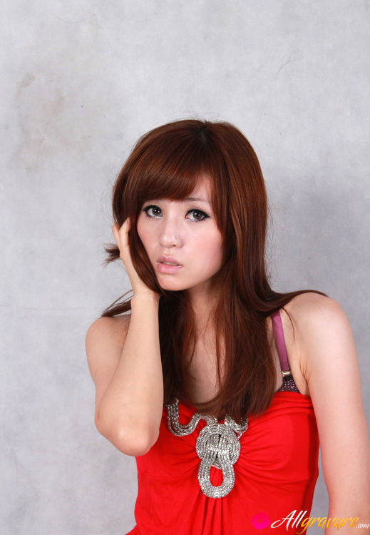 Female in a red dress and black heels poses against a grey background. - XXXonXXX - Pic 2