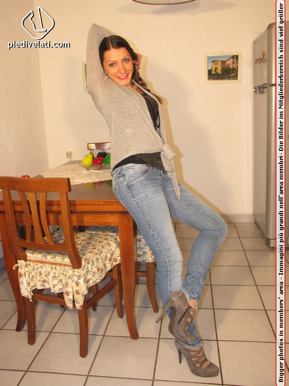 Cute chick in tight blue jeans drops shoes to display sweet cute feet on table - XXXonXXX - Pic 1