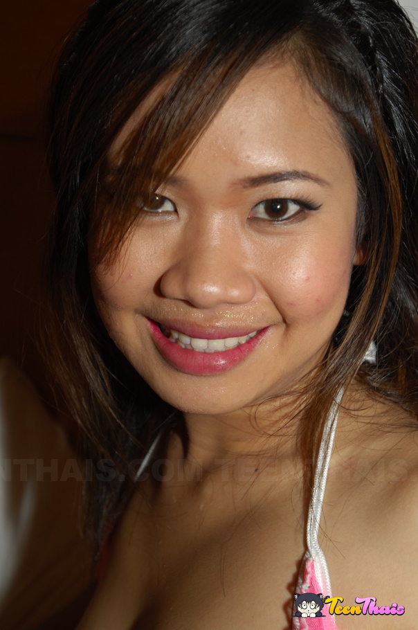 Cute Thai removes her floral dress and shows her skinny body wearing her green lingerie then she gets naked and expose her tiny tits and sweet pussy in her kitchen before she seduces a white hunk in her pink bra and mini skirt then sucks his cock before she rides on it on a brown and white bed. - XXXonXXX - Pic 15