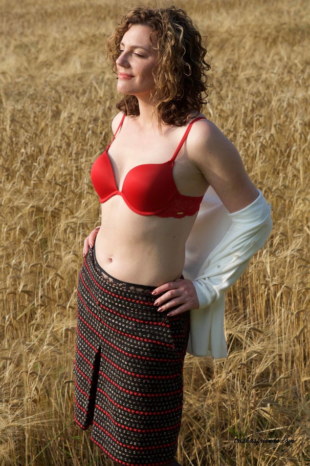 Foxy MILF peels off her white blouse and multi-colored skirt then displays her skinny body on a grass field wearing her red underwear and black stockings before she takes off her bra and bares her petite tits. - XXXonXXX - Pic 3