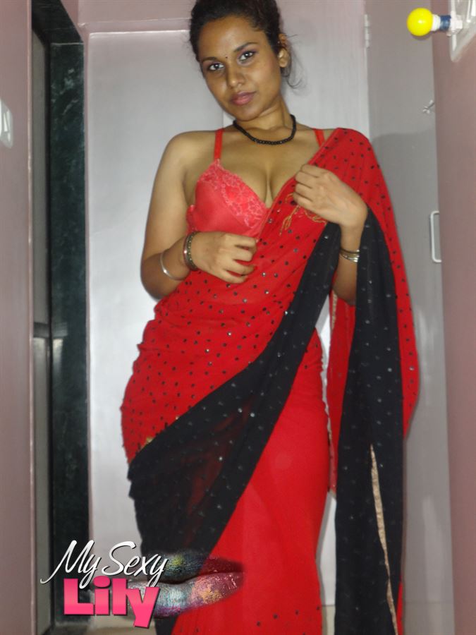 Stunning Indian chick displays her hot curves in red and black dress before she pulls it down and bares her hot tits with big nipples under her red bra on a gray and white bed. - XXXonXXX - Pic 3