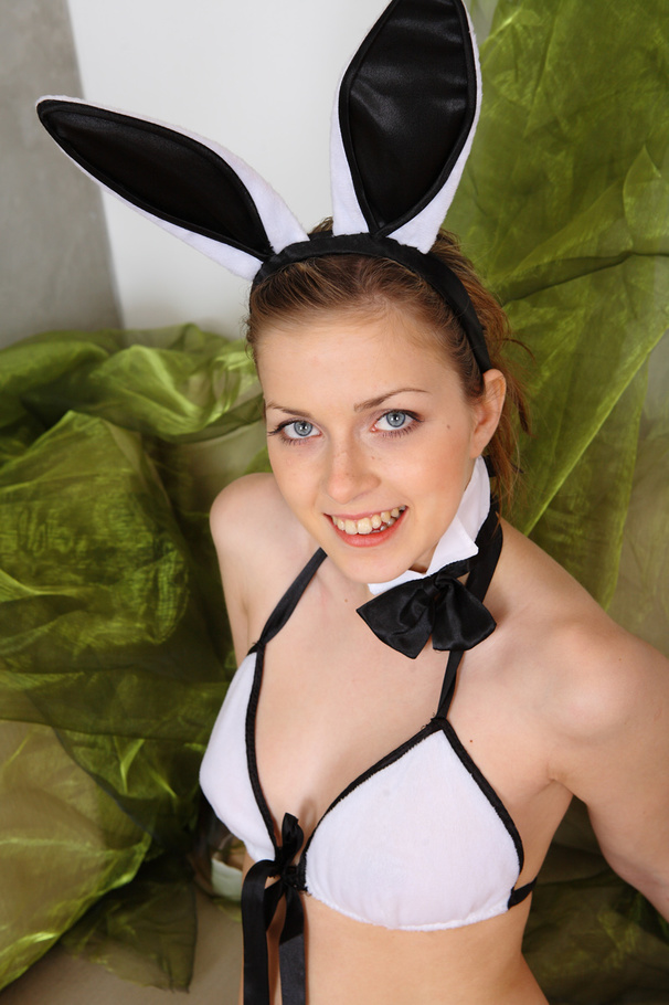Alluring babe with banging body wearing black and white bunny ears and bikini sucks a big carrot before she gets naked then shoves it in her wet pussy by a white couch. - XXXonXXX - Pic 2