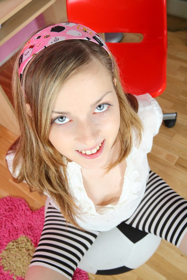 Lovely young hottie posing on a red and black ball before she takes off her white blouse and expose her petite boobs then she strips down her black and white stripe leggings then rubs and drills her sweet pussy with her purple vibrator on a red chair wearing her white rubber shoes. - XXXonXXX - Pic 2