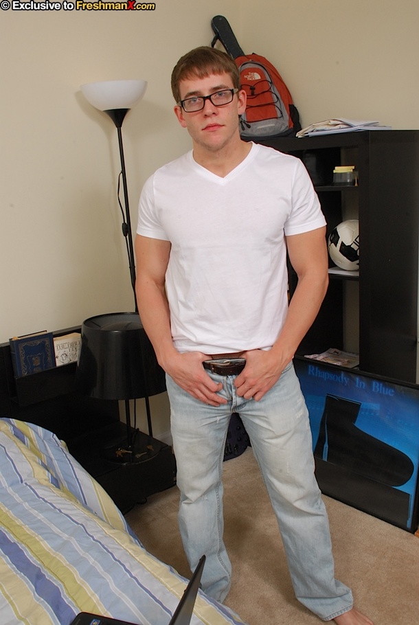 Nerdy dude strips off his white shirt and teases with his stone hard body with tattoos before he lays down on a multi-colored bed and pulls his big schlong out of his jeans. - XXXonXXX - Pic 1