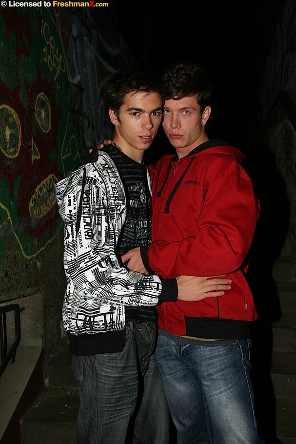 Pretty boy wearing black and white jacket, black shirt and jeans makes out with his handsome lover in red sweater and jeans before they take turns kneeling down and sucking each others cocks in a dark stairway. - XXXonXXX - Pic 1