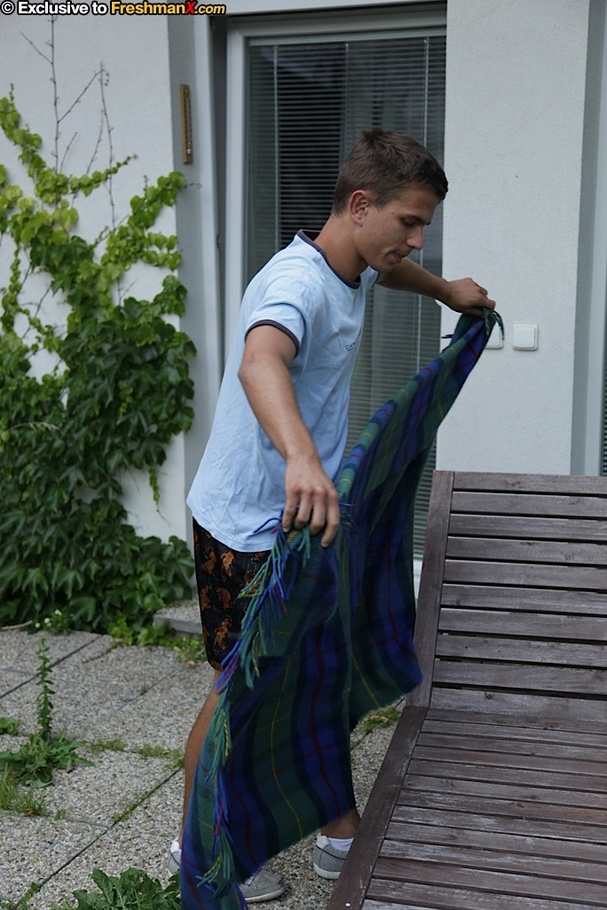 Gorgeous dude takes off his blue shirt and reveals his hunk body outdoor before he pulls down his blue and orange shorts and expose his butt crack and big cock on a green and blue beach bed. - XXXonXXX - Pic 1