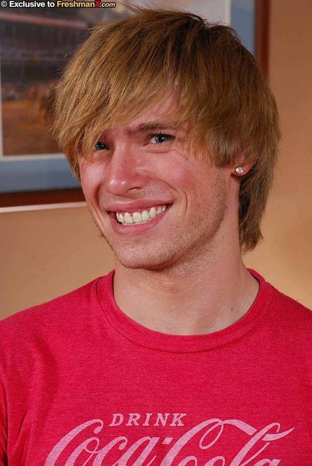 Stunning stud peels off his red shirt and bares his skinny body before he strips down his jeans and gray boxers and expose his giant meat stick as he sits naked on a brown couch. - XXXonXXX - Pic 1