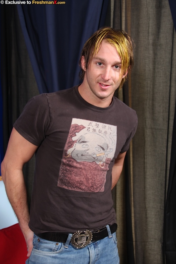 Blonde hunk wearing brown shirt and jeans slowly gets naked and pose his muscular body while he displays his humongous cock on a black couch. - XXXonXXX - Pic 1