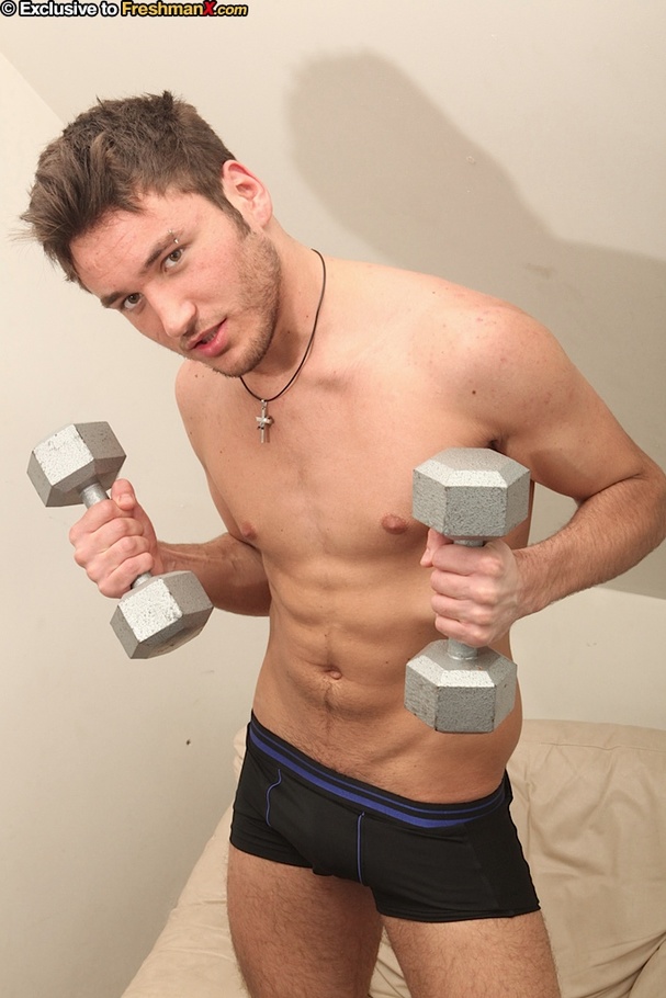 Gay stud sits on a light brown couch and takes off his red shirt and gray shorts then shows his stud body as he lifts some weights before he takes off his black pants and jacks off. - XXXonXXX - Pic 6