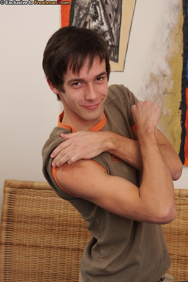 Hot twink takes off his brown shirt, pants and blue and white boxers then shows his hard body while he pumps his big dick on a blue bed. - XXXonXXX - Pic 1