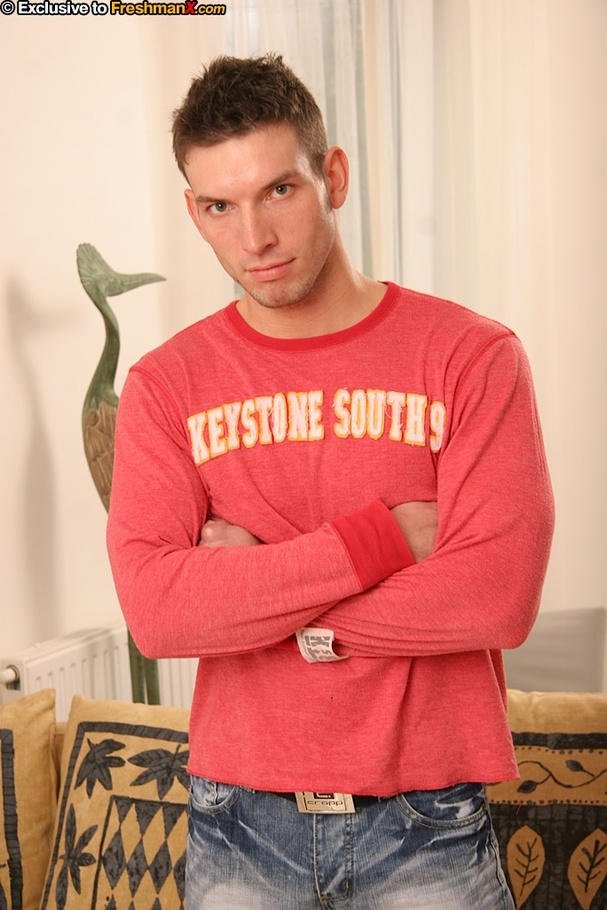 Hot dude takes off his pink shirt and shows his big body with huge muscles before he takes off his jeans and red and white striped brief and expose his large cock in different poses on a brown and green couch. - XXXonXXX - Pic 1