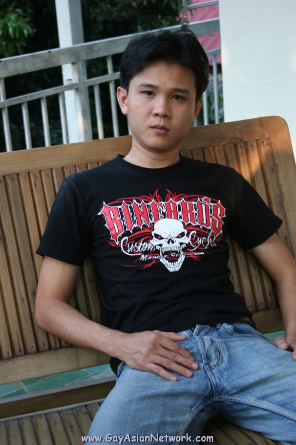 Handsome Asian guy sits on a wooden couch o - XXX Dessert - Picture 1