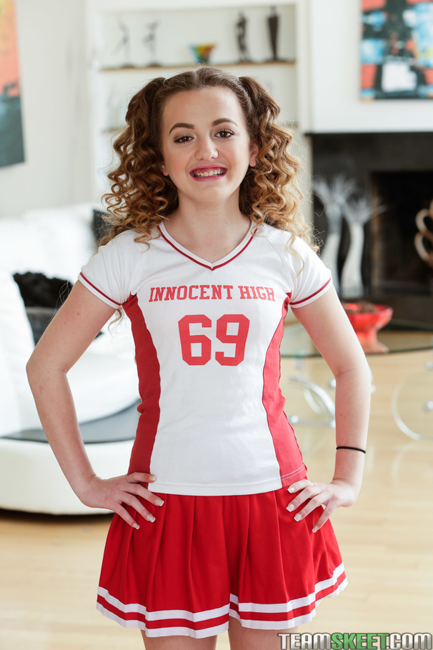 Curly-haired brunette in red cheerleading o - XXX Dessert - Picture 1
