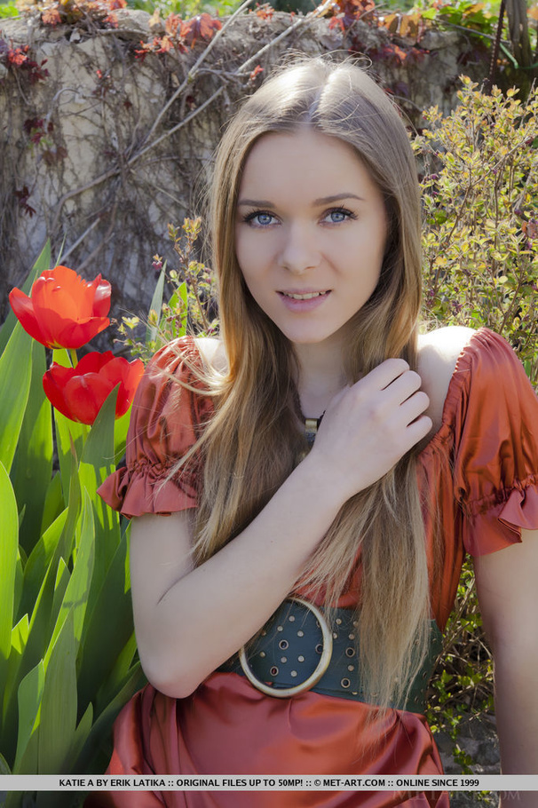 Blonde in red gown likes to stroll at the garden and gets naked on the stones - XXXonXXX - Pic 1