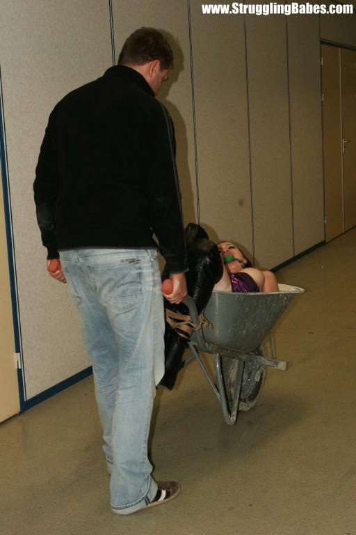 Lovely brunette in purple top bound in wheel barrow, gagged and squeezed - XXXonXXX - Pic 11