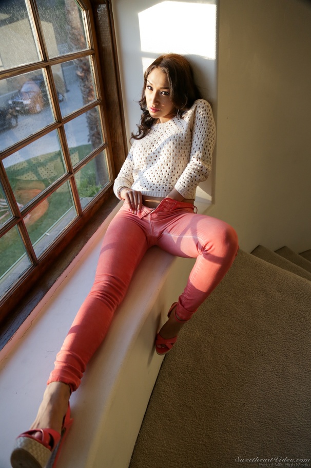 Asian brunette takes off her orange pants near a window - XXXonXXX - Pic 2