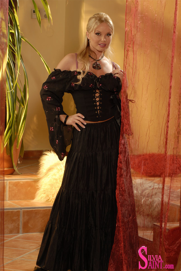 Exquisite blonde in black flowery lace up dress making sure her body is noticed in front of a camera - XXXonXXX - Pic 1