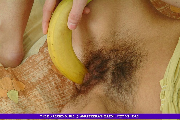 Skinny granny shows her petite tits as she lays naked on a brown and green bed while she shoves a big banana deep in her twat. - XXXonXXX - Pic 4