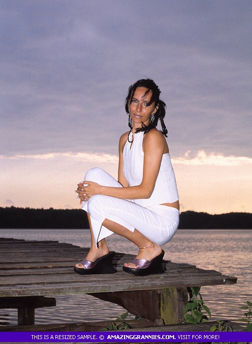 Luscious grandma pose her skinny body outdoor wearing her white dress and black high heels before she goes inside and expose her lusty boobs and nasty pussy in different positions on a maroon couch. - XXXonXXX - Pic 2