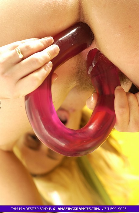 Gorgeous blonde teases with her sweet boobs and foxy body as she screws her holes with a long red dildo in different positions wearing her green shirt, skirt and black boots on a green chair. - XXXonXXX - Pic 4