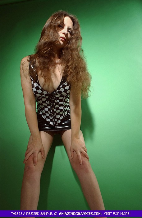 Luscious granny displays her steaming hot body then shows her hairy crack in different poses wearing her black and white dress and black high heels in a green room. - XXXonXXX - Pic 10