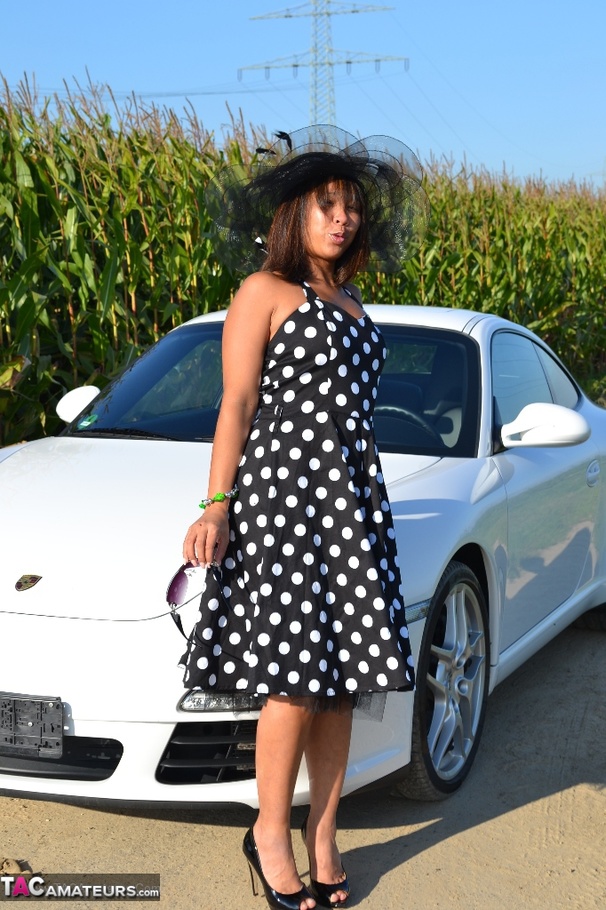 Hot Asian babe poses by an expensive car and strips all of her clothes - XXXonXXX - Pic 1
