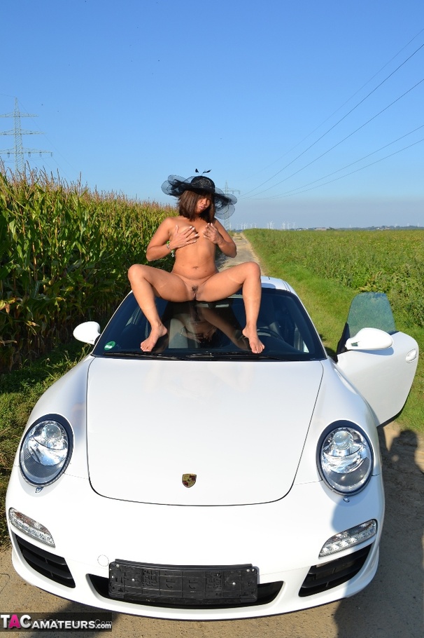 Hot Asian babe poses by an expensive car and strips all of her clothes - XXXonXXX - Pic 17