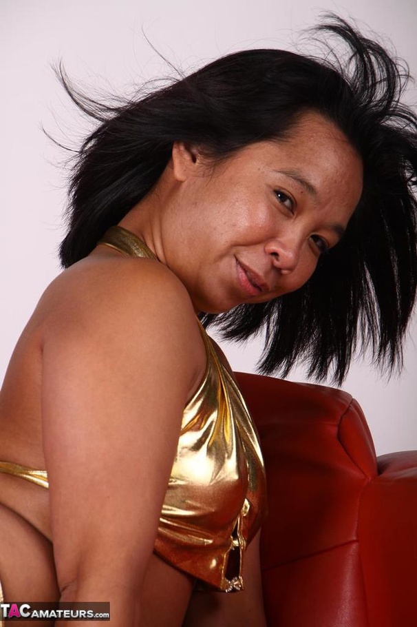 Tanned Asian slut poses rather seductively, while wearing sexy golden underwear - XXXonXXX - Pic 17