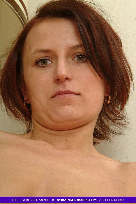 Redhead granny pose naked and displays her juicy boobs and nasty pussy in different positions on a wooden chair. - XXXonXXX - Pic 2