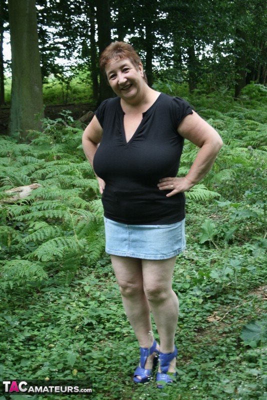 Mature BBW displays her plus size body in black shirt, jeans skirt and blue high heels then shows her extra large boobs in the woods. - XXXonXXX - Pic 1